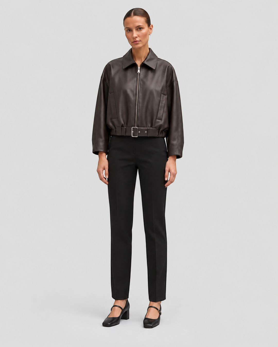 Luna Moda Alessandra brown faux leather jacket with adjustable waist belt worn by a model with black trousers