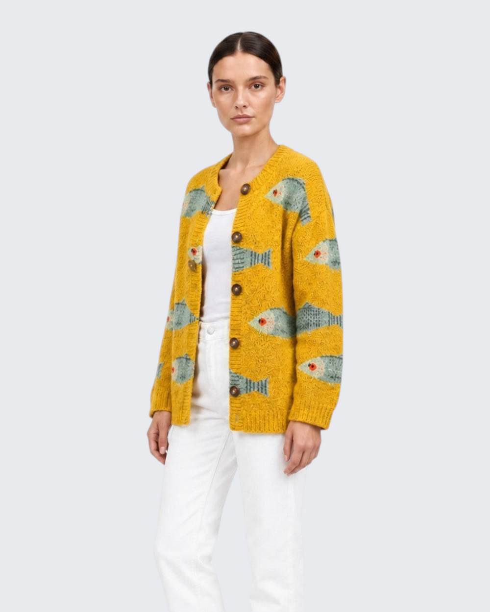 Luna Moda Allegra cardigan in vibrant golden yellow knit with a playful fish print and round button front closure.