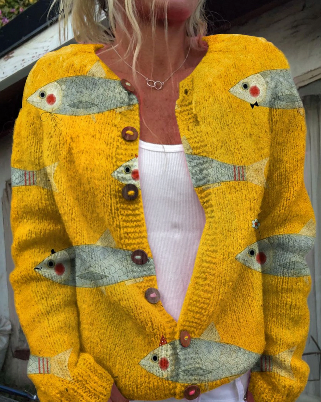 Luna Moda Allegra cardigan in vibrant golden yellow knit with a playful fish print and round decorative buttons.