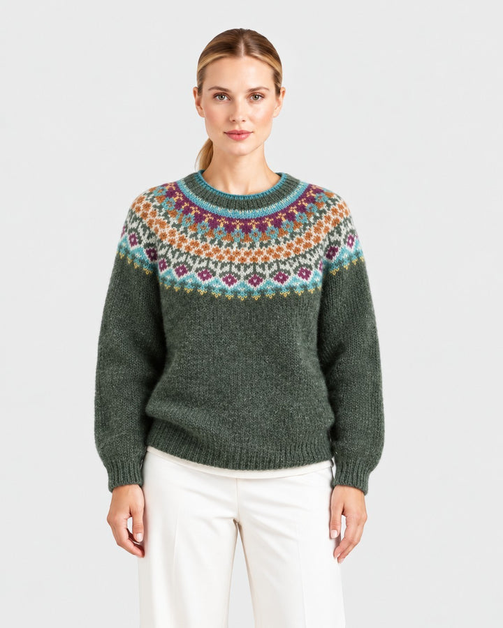 Luna Moda Ambra crewneck sweater in dark green with a colorful Icelandic-style patterned yoke on a female model