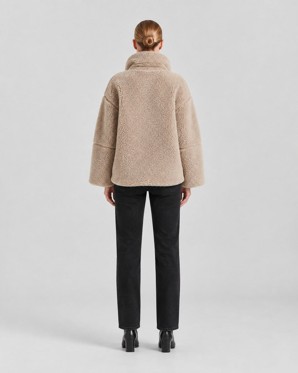 Luna Moda Anastasia beige fleece coat with a loose fit and high collar, worn by a woman from the back view.