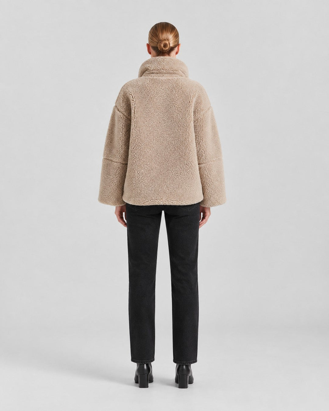 Luna Moda Anastasia beige fleece coat with a loose fit and high collar, worn by a woman from the back view.