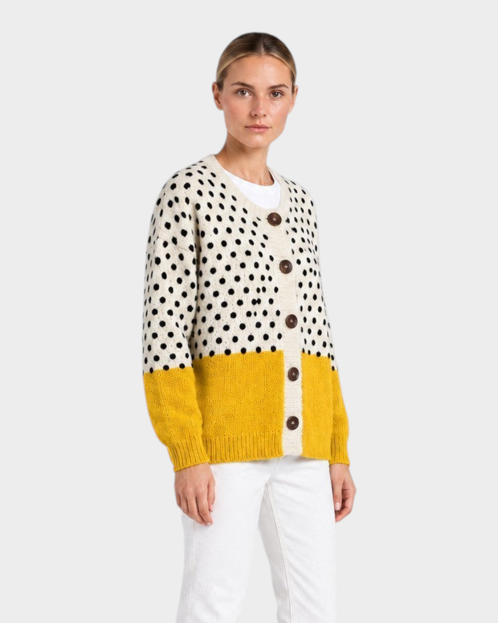 Luna Moda Angelica knit cardigan with cream polka dot top, mustard yellow bottom, and wooden buttons on a model