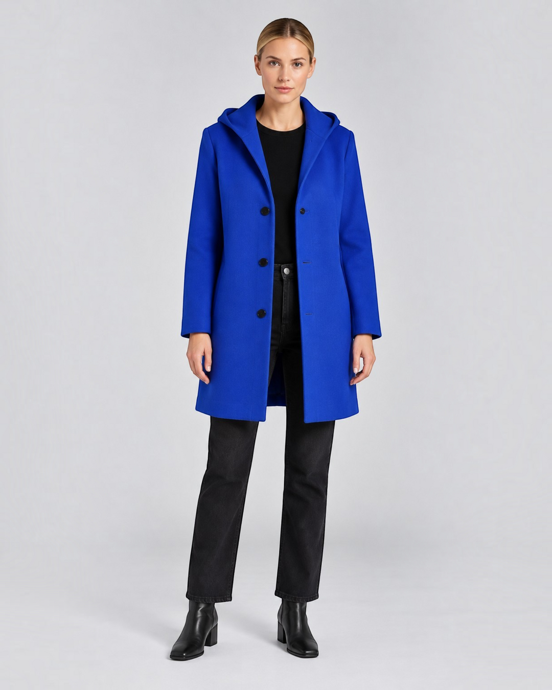 Luna Moda Annetta short blue coat with a hood and button closure worn by a model with black jeans and boots