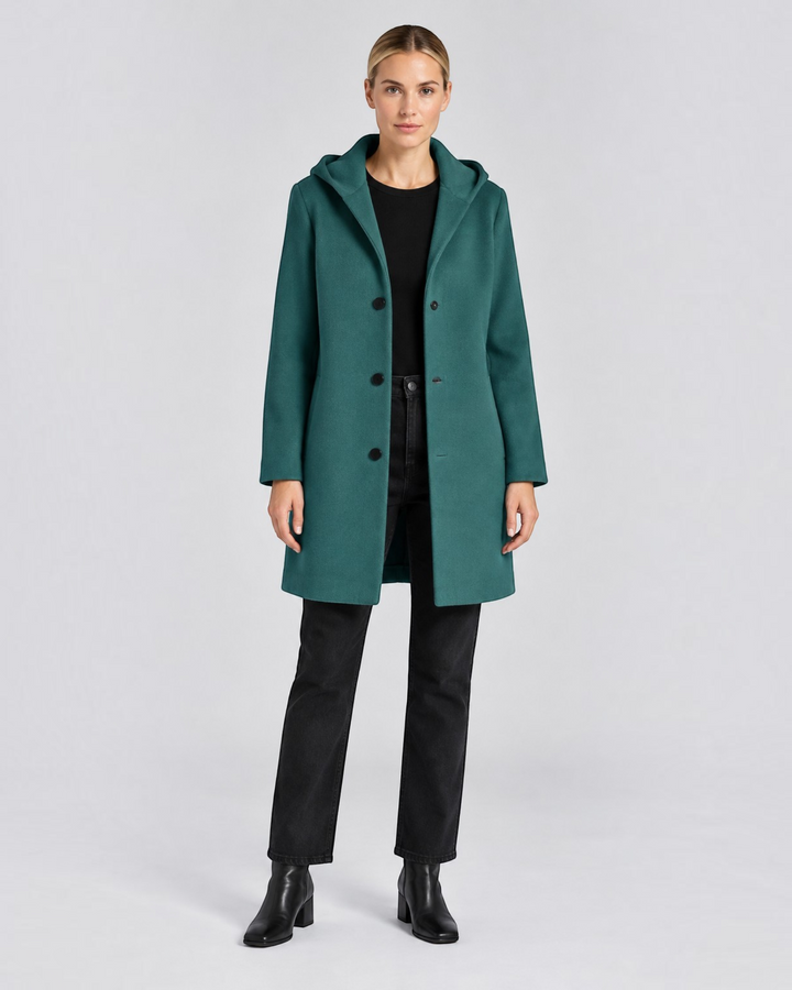 Luna Moda Annetta short green hooded coat with button closure worn by a woman with black jeans and ankle boots