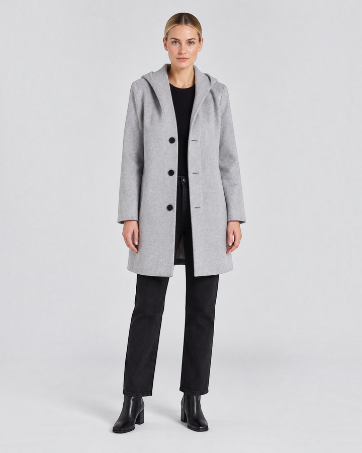 Luna Moda Annetta short grey hooded coat with button closure worn by a woman with black jeans and boots
