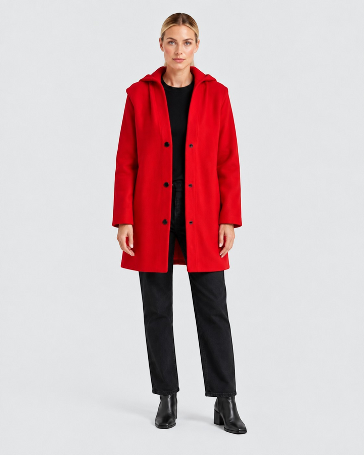 Luna Moda Annetta short red coat with a hood and black button closure worn by a woman with black jeans and boots