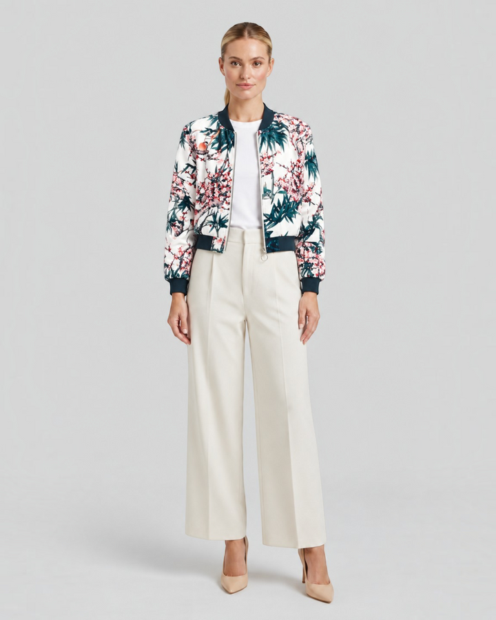 Luna Moda Arianna bomber jacket with vibrant floral print, long sleeves, and dark ribbed trim on a female model