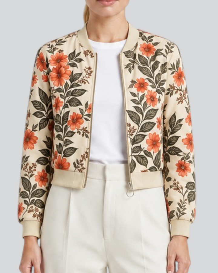 Luna Moda Arianna bomber jacket in beige with vibrant orange floral print, worn by a model with white trousers.