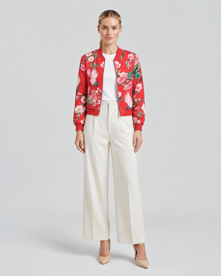 Luna Moda Arianna bomber jacket in red with vibrant floral print, worn by a model with white trousers