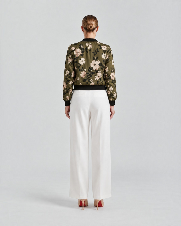Luna Moda Arianna bomber jacket in olive green with floral print, worn with white trousers, back view.