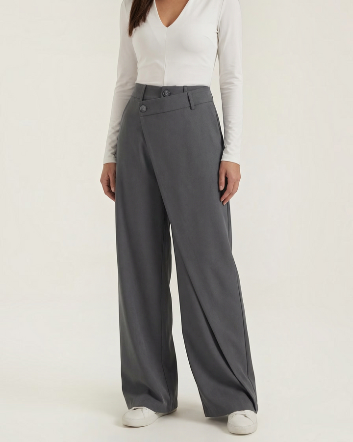 Luna Moda Licia wide-leg trousers in charcoal grey with an asymmetric wrap front panel and button detail.