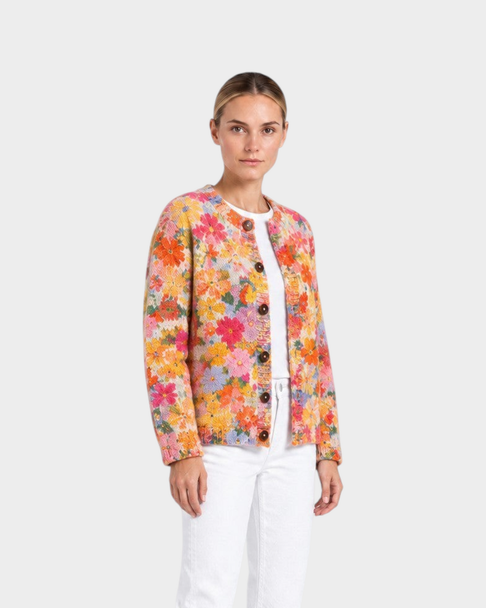 Luna Moda Aurora cardigan featuring a vibrant hand-painted floral pattern in amber, coral, and blue on a model.