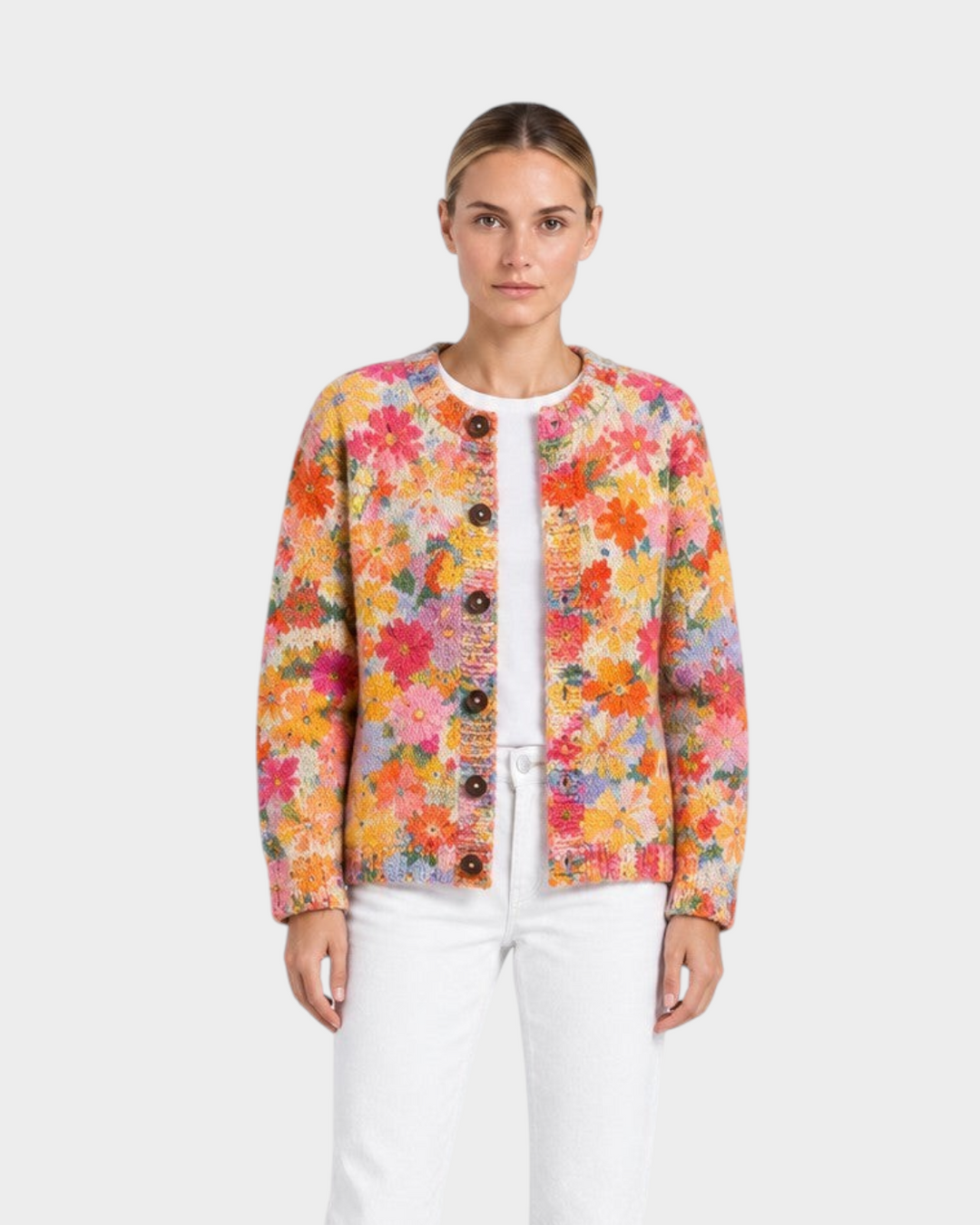 Luna Moda Aurora cardigan featuring a vibrant hand-painted floral pattern in amber, coral, and pink with dark buttons.