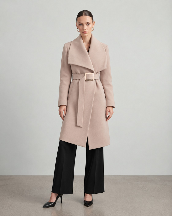 Luna Moda beige long coat with a wide collar and belted waist worn by a model with black trousers and heels