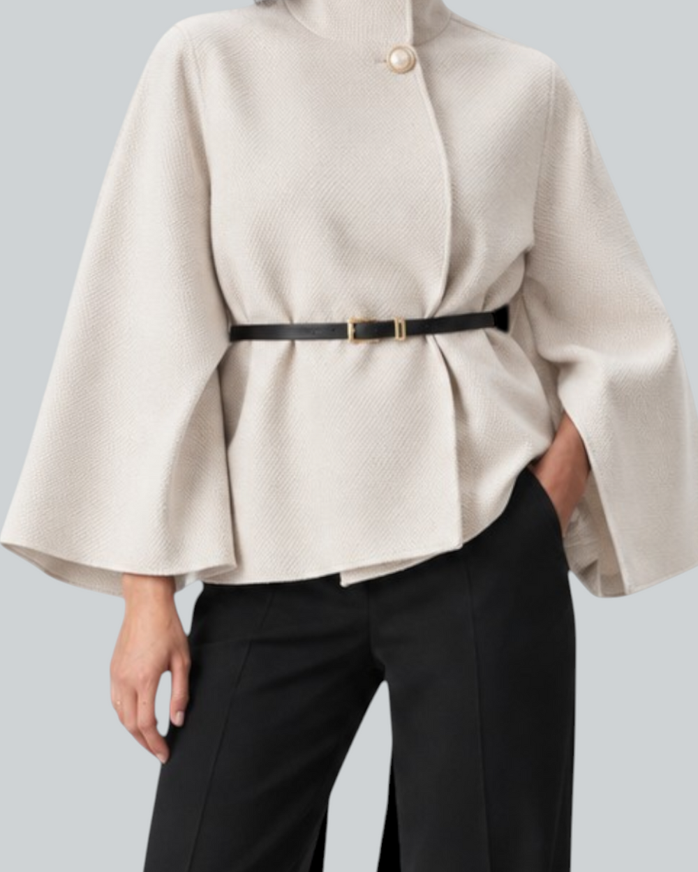 Luna Moda beige butterfly sleeve coat with a belted waist worn by a model with black trousers and heels.