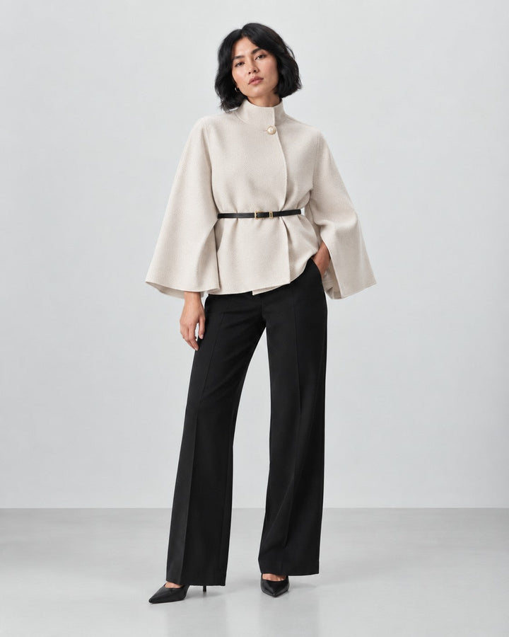 Luna Moda beige butterfly sleeve coat with a waist belt worn by a model with black trousers and heels.
