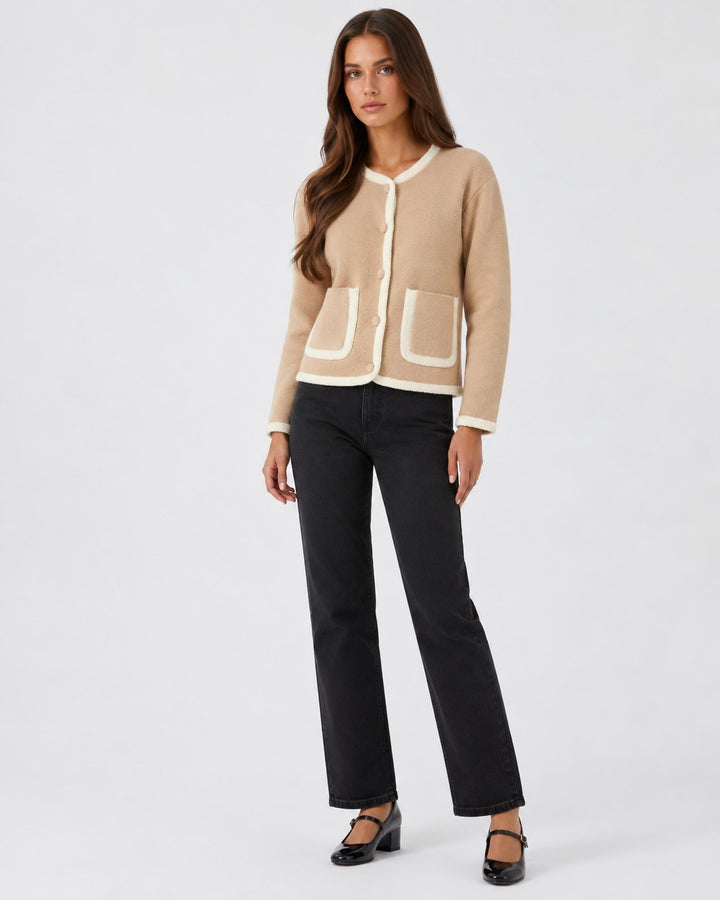 Luna Moda beige cropped cardigan with white contrast piping, front pockets, and button closure worn by a model.