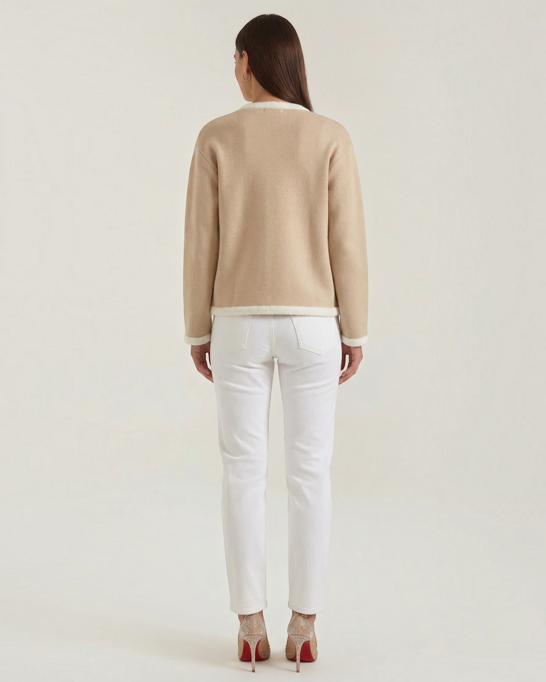 Luna Moda beige cropped cardigan with white contrast piping, worn by a model from the back with white jeans.