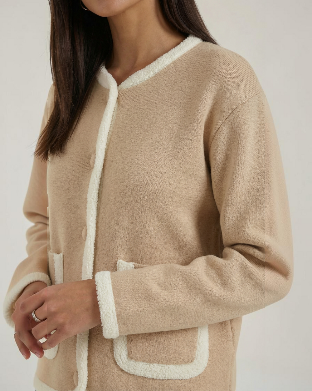 Luna Moda beige cropped cardigan with white contrast piping, button front, and patch pockets on a model