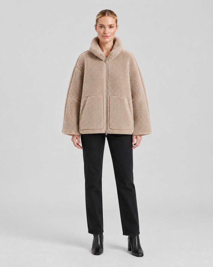 Luna Moda Anastasia beige fleece zip-up coat with hood and pockets worn by a model with black jeans
