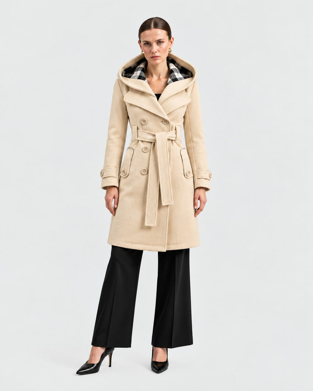 Luna Moda beige hooded winter coat with a belted waist and plaid lining worn by a model in a studio setting.