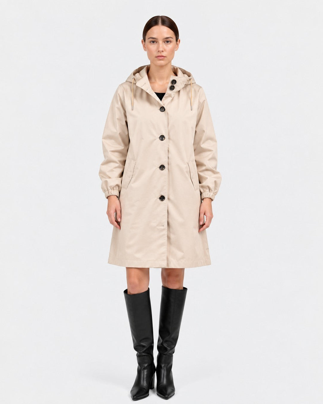 Luna Moda beige oversized waterproof raincoat with hood and button closure worn by a model with black boots