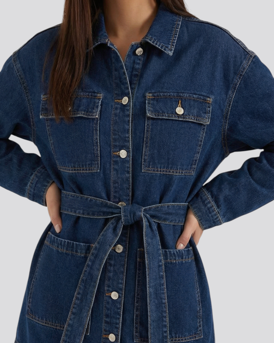 Luna Moda Alice relaxed fit dark blue denim jacket with a tie waist belt and front pockets worn by a model