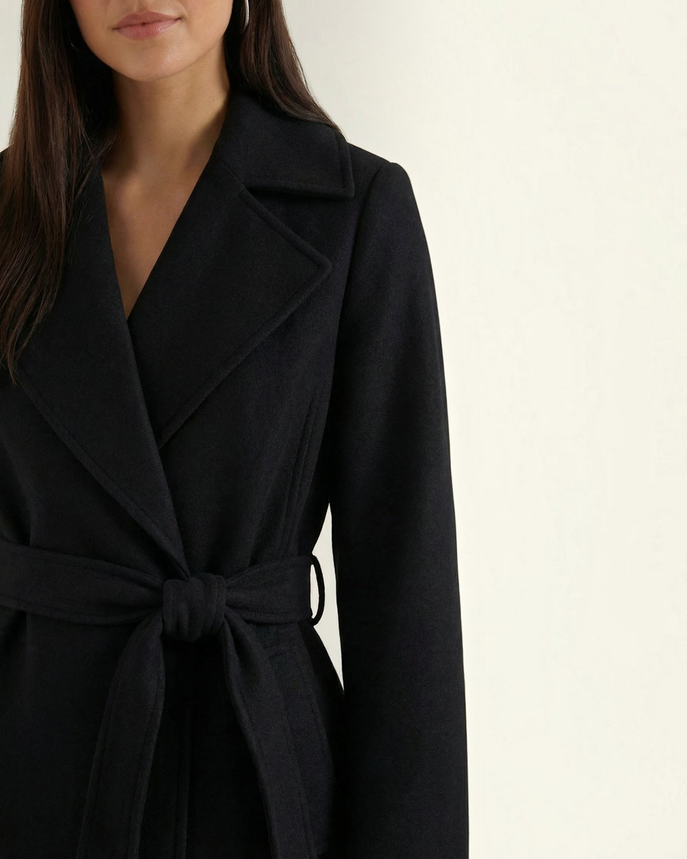Luna Moda black wool-blend trench coat with a belted waist and classic lapel collar worn by a woman