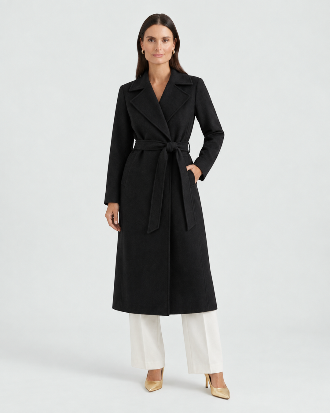 Luna Moda black wool-blend trench coat with a belted waist, worn by a model with white trousers and gold heels.