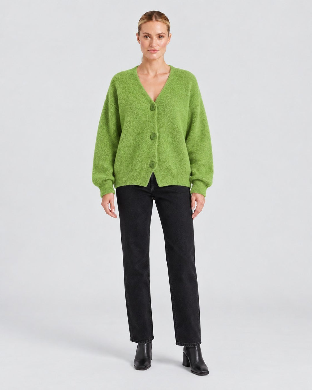Luna Moda BIANCA relaxed fit lime green knit cardigan worn by a model with black jeans and ankle boots.