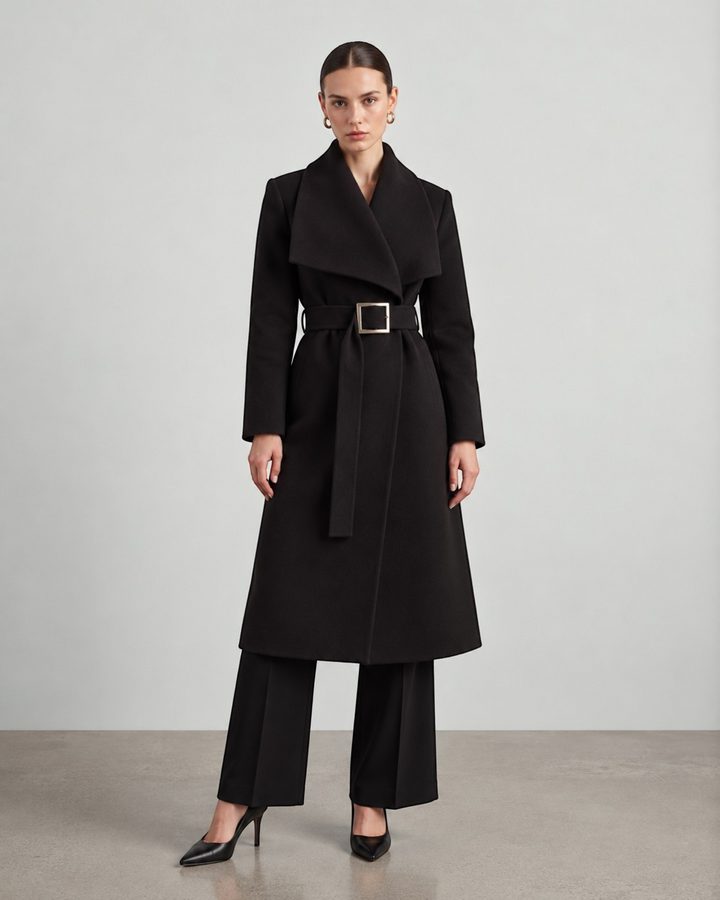 Luna Moda black long coat with a wide collar and belted waist worn by a model in a studio setting