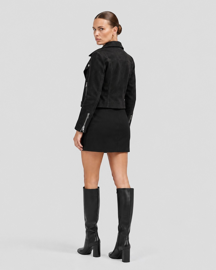 Luna Moda black biker spring jacket with silver zippers and wide collar worn by a model with a matching mini skirt