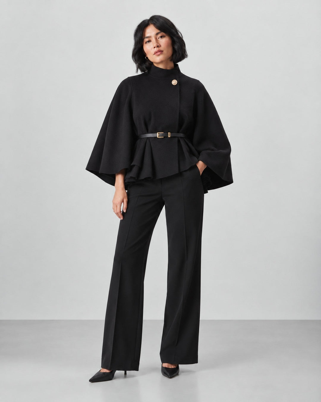 Luna Moda black Serena coat with butterfly sleeves and belted waist worn by a model with black trousers and heels