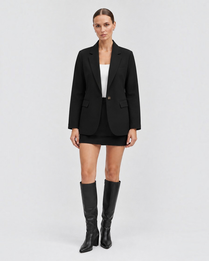 Luna Moda black classic blazer worn by a model with a white top, black mini skirt, and knee-high boots