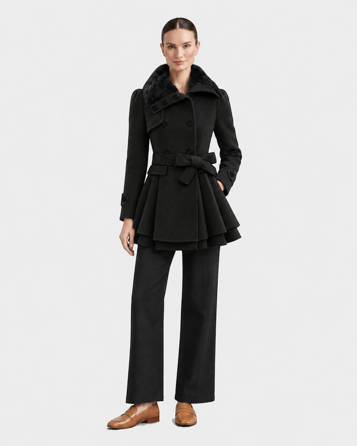 Luna Moda black flared winter coat with faux fur collar and belted waist worn by a model with matching trousers