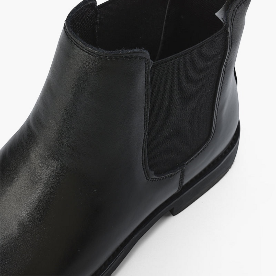 Luna Moda black leather slip-on ankle boot with elastic side panels and pull tab on a clean white background.