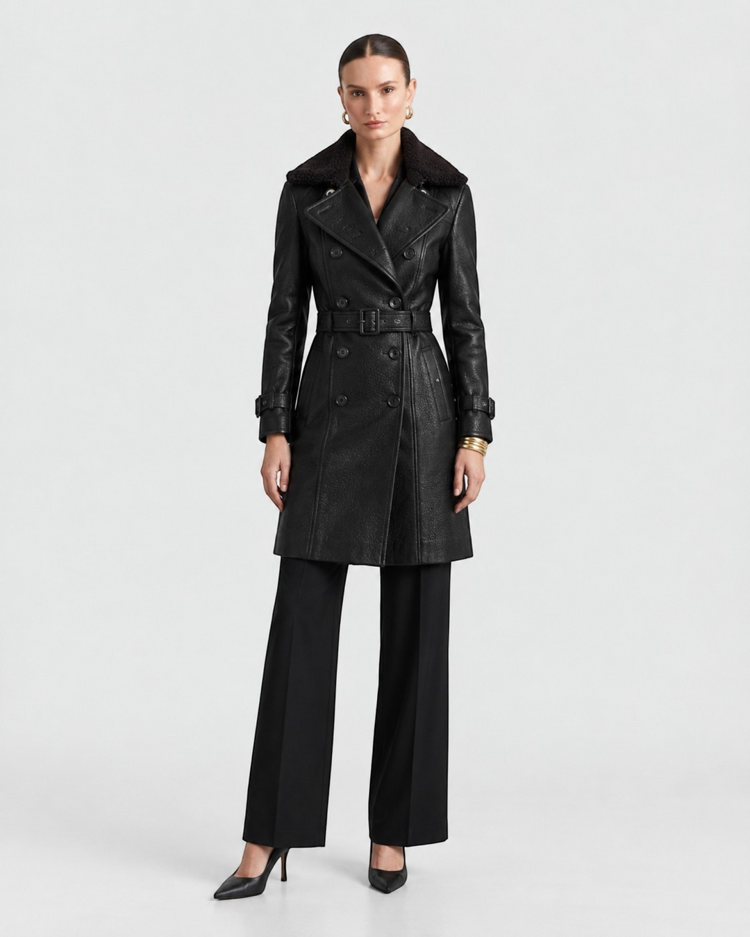 Luna Moda black leather coat with a wide collar, double-breasted buttons, and a belted waist on a female model.