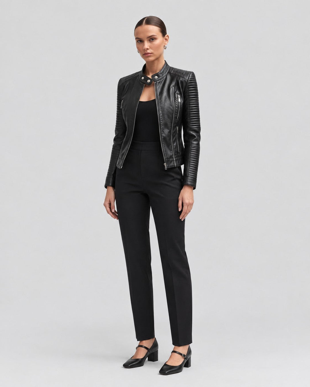 Luna Moda black leather jacket with ribbed sleeve details worn by a model with black trousers and heels
