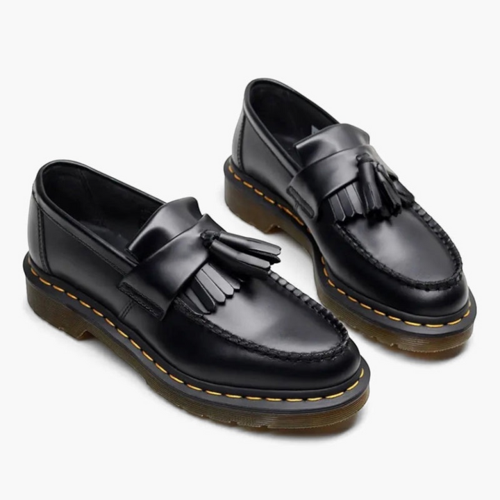 Luna Moda black leather tassel loafers featuring a kiltie fringe and yellow contrast stitching on a rubber sole.