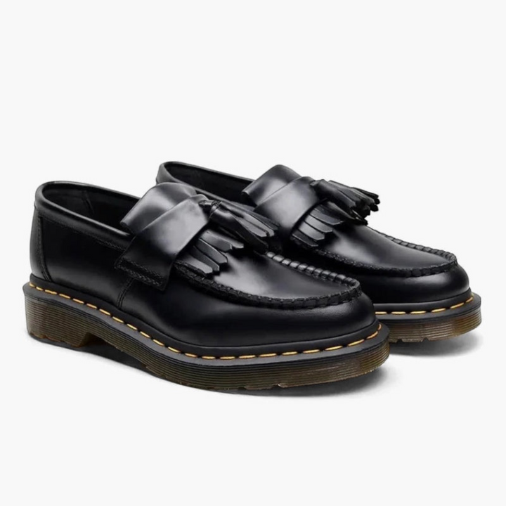 Luna Moda black leather loafers featuring a classic tassel design, fringe detail, and durable yellow-stitched soles.