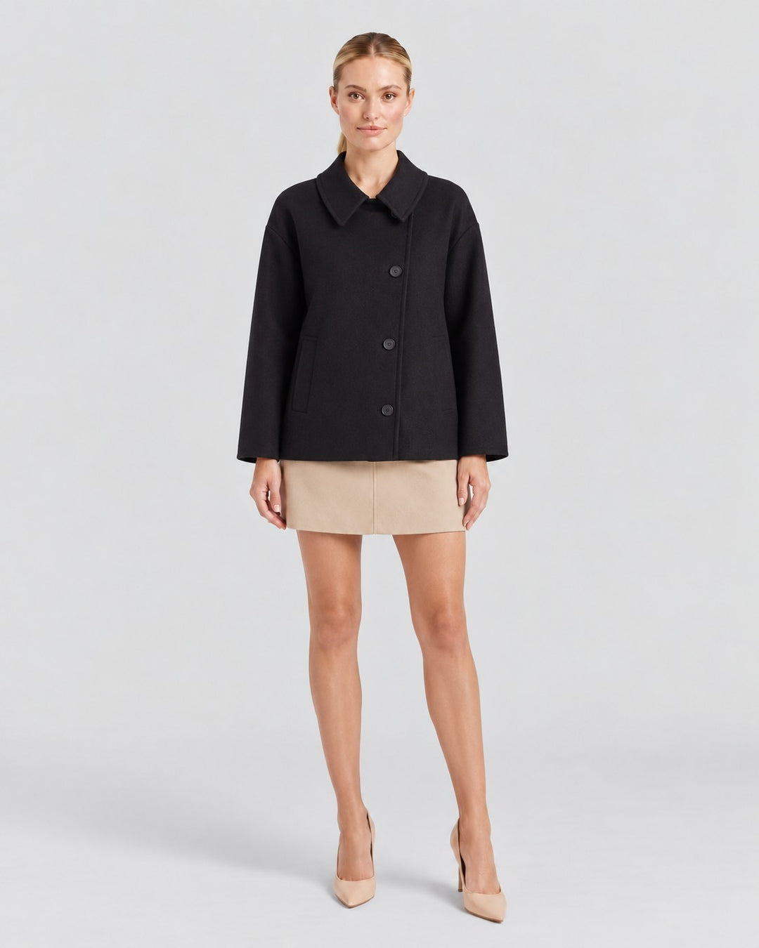 Luna Moda black oversized wool coat with asymmetric button closure and classic collar worn by a model