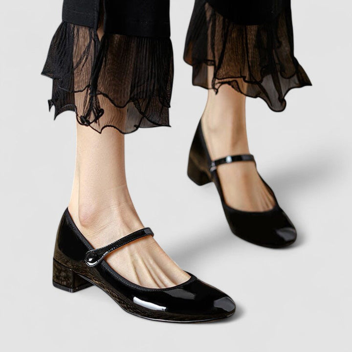 Luna Moda Cloé black patent leather Mary Jane shoes with a thin strap and comfortable block heel on a model