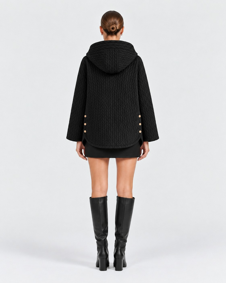 Luna Moda black quilted hooded jacket with decorative side buttons worn by a model from the back view