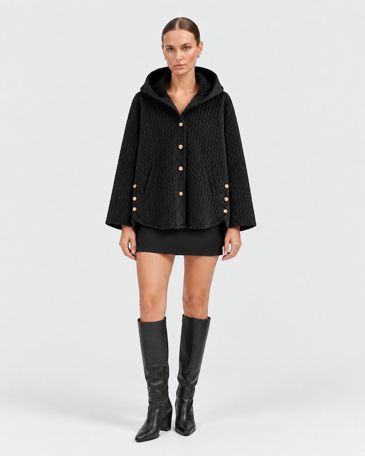 Luna Moda black quilted hooded jacket with decorative gold buttons worn by a model with a black mini skirt and boots