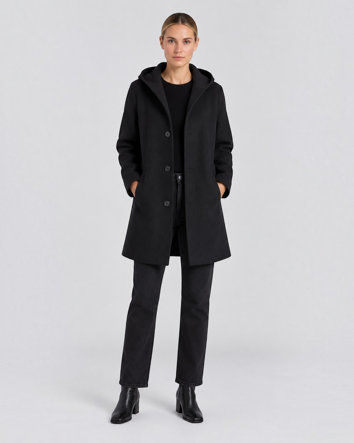 Luna Moda black short hooded coat with button closure worn by a woman with black jeans and boots