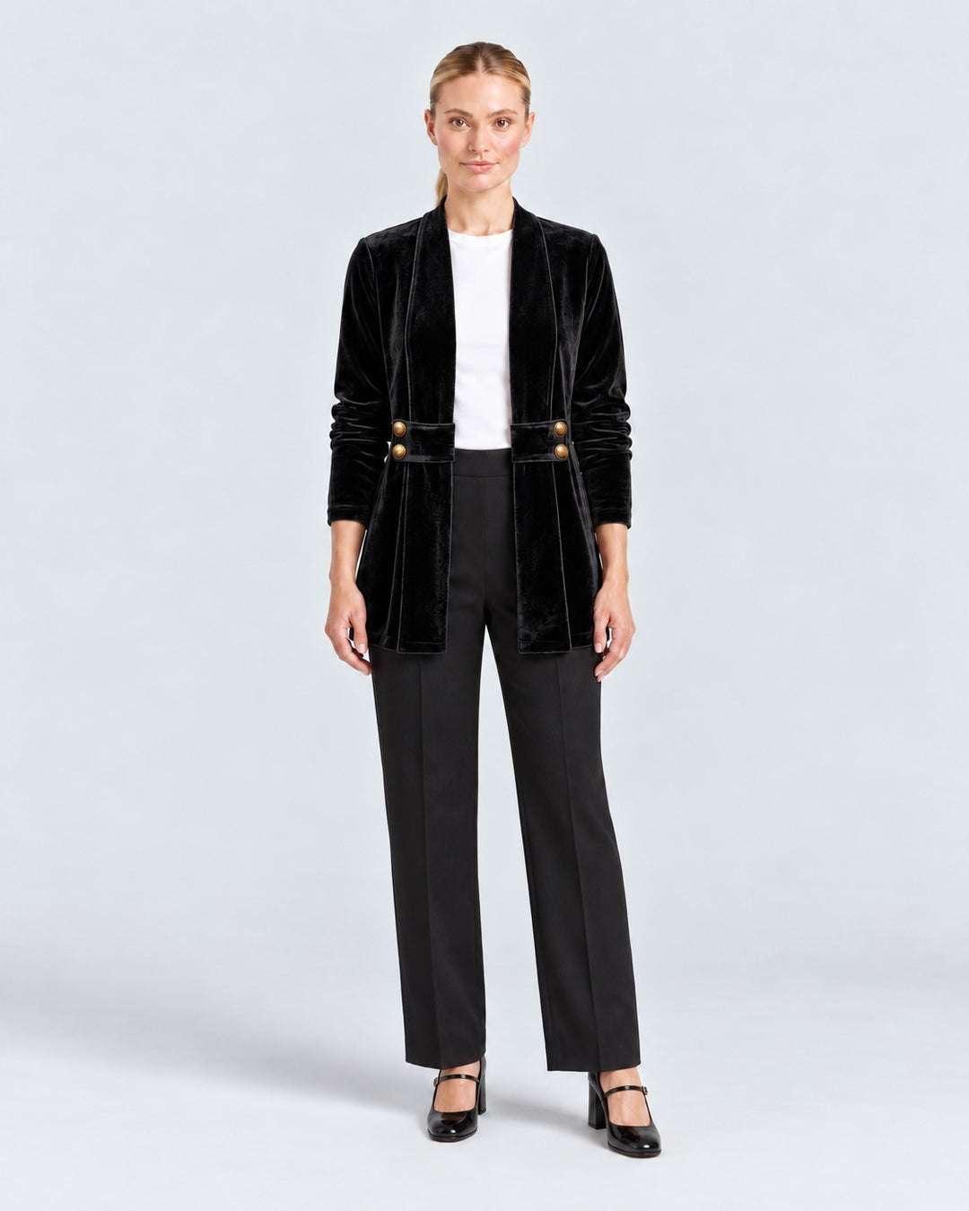 Luna Moda Donatella black velvet blazer with long sleeves, open front, and gold button details worn by a model.