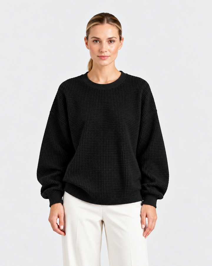 Luna Moda Lucia black waffle knit sweater with a relaxed oversize fit, crew neckline, and long sleeves on a model.