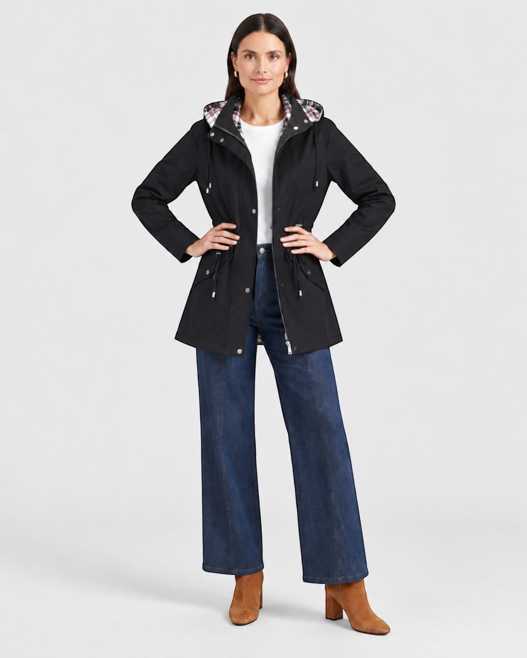 Luna Moda black waterproof hooded jacket with adjustable waist and plaid lining worn by a model with blue jeans