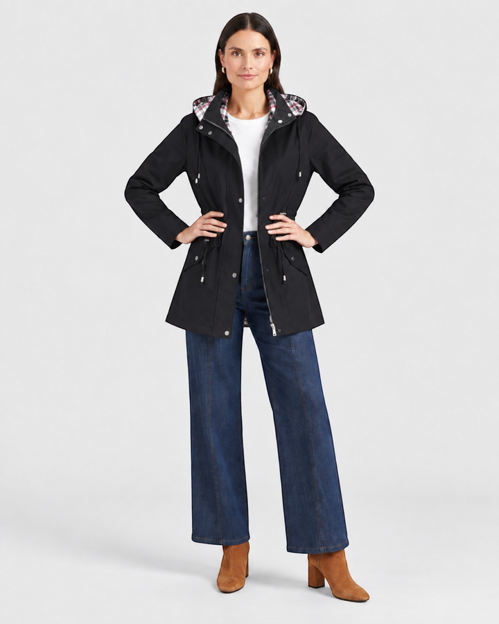 Luna Moda black waterproof hooded jacket with adjustable waist and plaid lining worn by a model with blue jeans